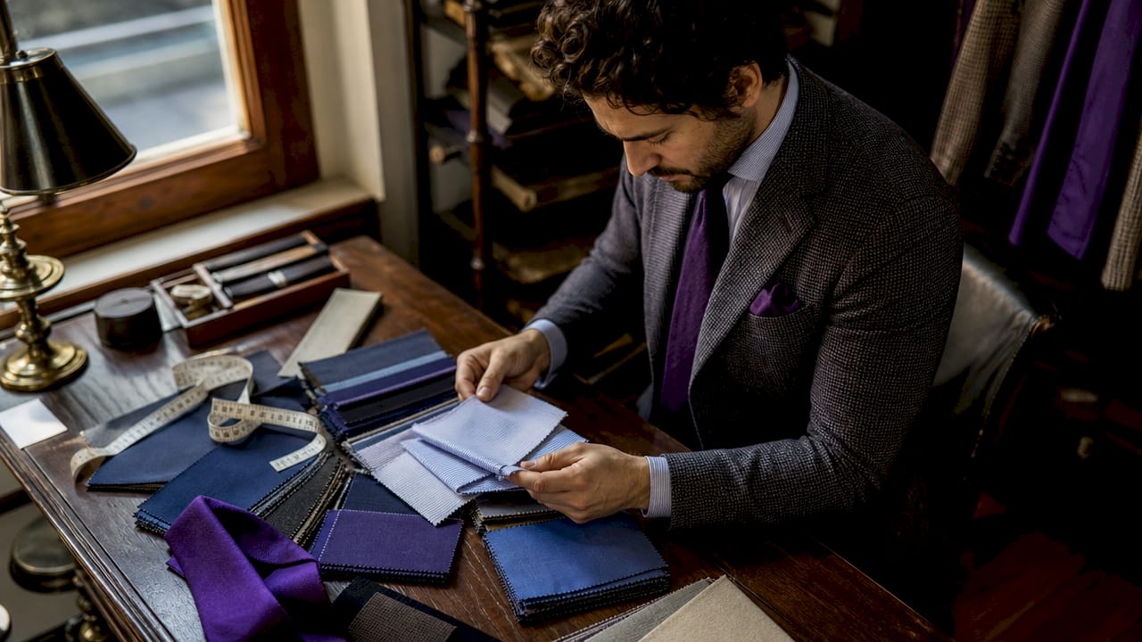 Consultant examining dress shirt fabric swatches