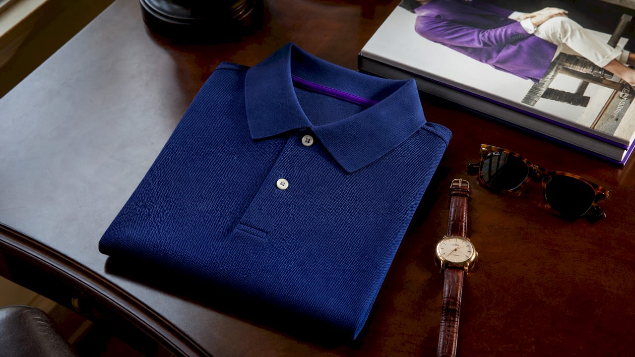 Folded navy pique fabric polo shirt flat lay