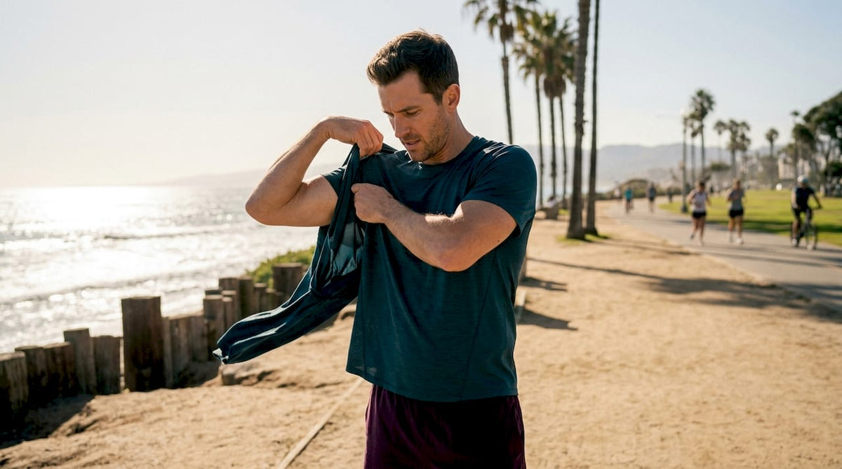 Man putting on outdoor workout tee