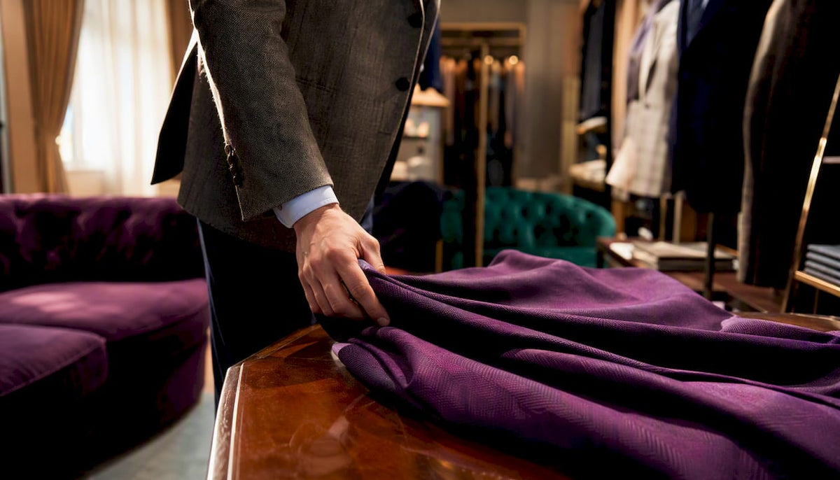 Hand draping fabric to check quality