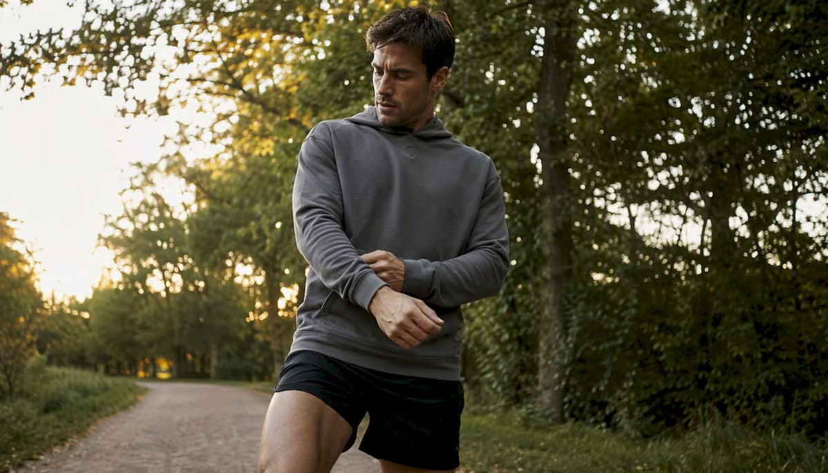 Athlete adjusting hoodie sleeve outdoors