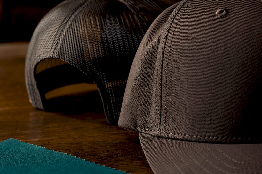 Contrasting solid fabric and mesh hat construction